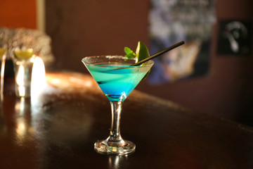 Cocktail on bar counter on bar background