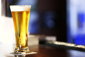 Cold beer glass on bar or pub desk