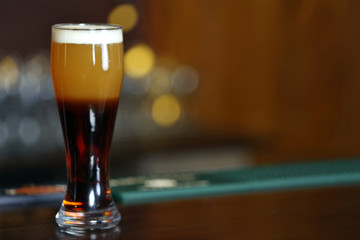 Cold beer glass on bar or pub desk