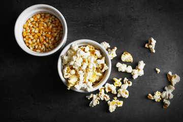 Popcorn in bowls on dark background
