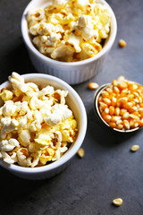 Popcorn in bowls on dark background