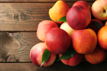 Fresh peaches on wooden background