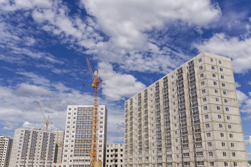 Fototapeta na wymiar Construction of multistorey building and big cranes