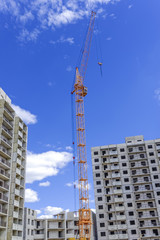 Fototapeta na wymiar Building multistorey houses and hoisting tower cranes