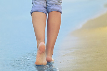 Woman walking on sand beach