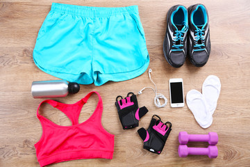 Sport equipment for woman  on wooden background