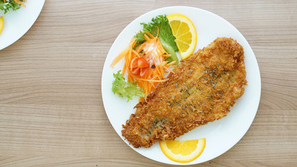 battered fish steak with salad and vegetable