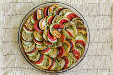 Ratatouille - traditional French Provencal vegetable dish. Food in glass brazier on lien tablecoth