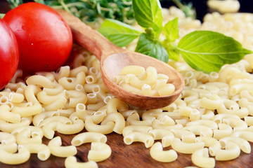 Raw Chifferi pasta with wooden spoon