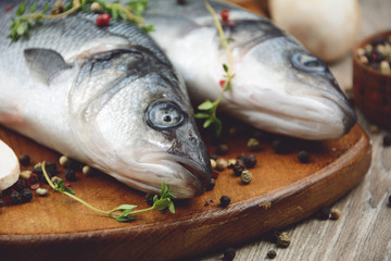 Raw seabass fish on the wooden board