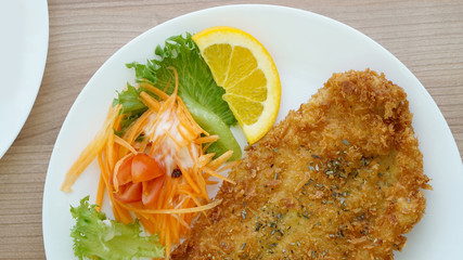 battered fish steak with salad and vegetable