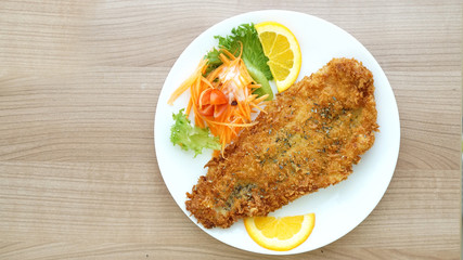 battered fish steak with salad and vegetable