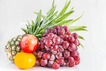 Fototapeta na wymiar Grapes and fruits on background.