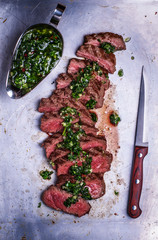 Sliced beef barbecue steak with chimichurri sauce © tbralnina