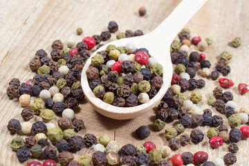 Color pepper on a wooden background.