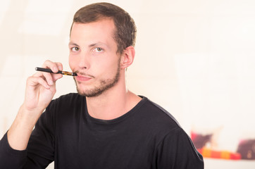 Hispanic man wearing dark sweater enjoying an electronic