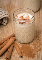 Egg nog in mason jar with cinnamon sticks