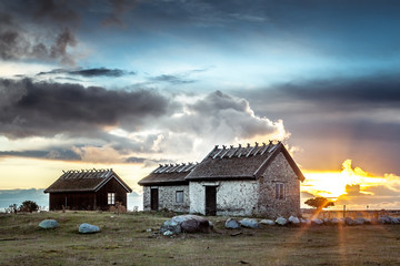 Sunrise behind the clouds and Swedish Traditional House (Ottenby is the far south of the island and...