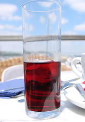 Red drink in a glass with ice