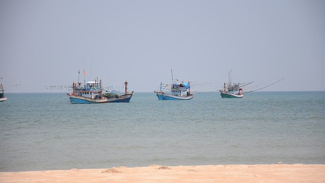 Fishing boat floating on the sea wait moor go to dock at Surat Thani, Thailand