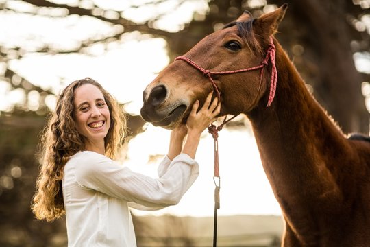 Young happy woman with her horse