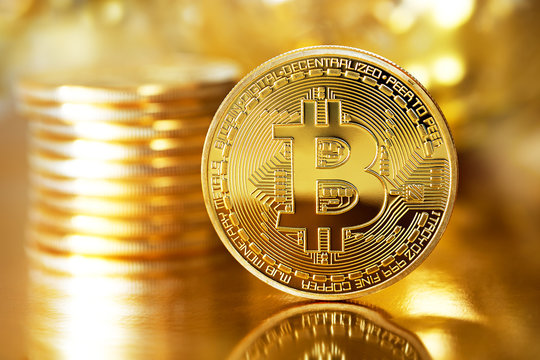 Golden Bitcoins on a gold background .Photo (new virtual money ) 