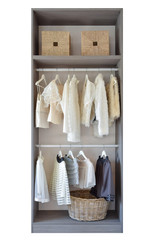 modern closet with row of white dress and shoes hanging in wardr