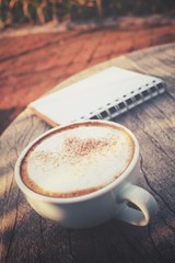 Coffee cup with blank notepad