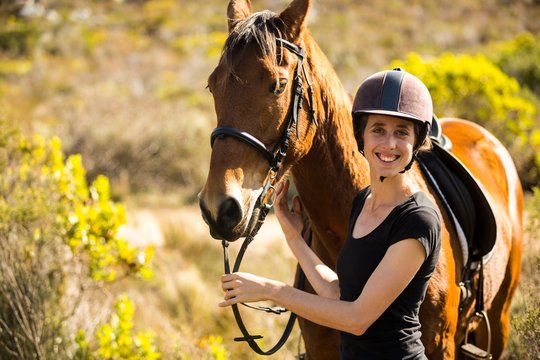 Young happy woman with her horse