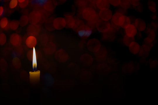 candle flame with abstract bokeh color background