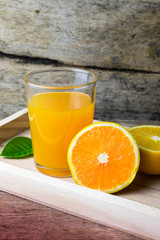 Glass of orange juice on wooden table, fresh drink