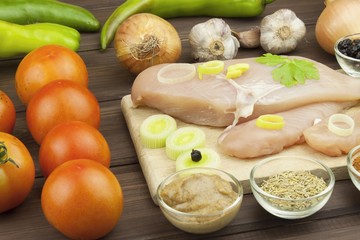 Preparing Diet food. Fresh raw chicken fillet and vegetables prepared for cooking. Fresh raw chicken breasts. Preparing chicken at a summer barbecue. Cooking with fresh dietary ingredients.
