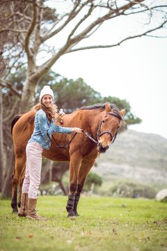 Young woman with her horse taking photo