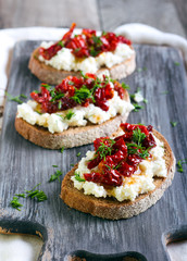 Bread slices with ricotta cheese and, sun dried tomatoes