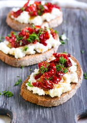 Bread slices with ricotta cheese and, sun dried tomatoes