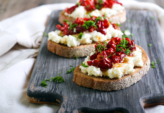 Bread slices with ricotta cheese and, sun dried tomatoes