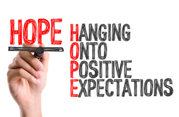 Hand with marker writing: Hope Acronym
