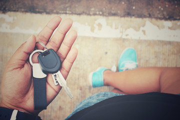 Fototapeta premium Selfie of sneaker with key car on hand