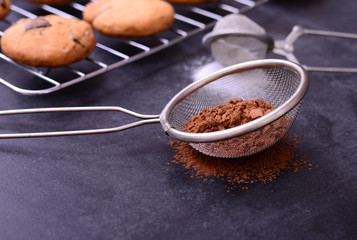 Brown chocolate powder on black background
