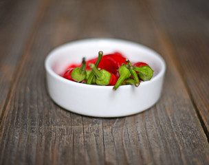Chilly pepper on the wooden background