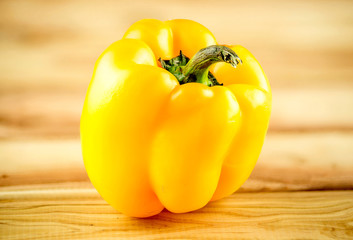 Ripe, organic Yellow capsicum on chopping board