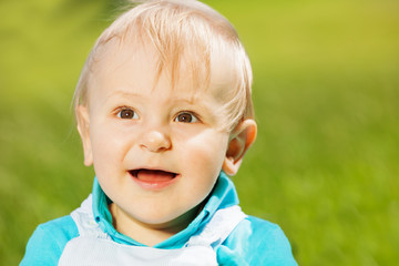 Portrait of smiling toddler on the green grass