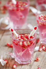 Pink cocktails for Valentine's Day with pomegranate seeds and tu