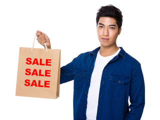 Man hold with shopping bag and showing three sale words
