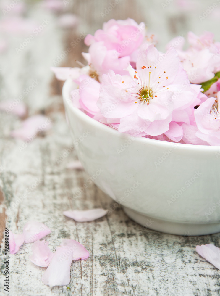 Sticker flowers of sakura blossoms in a bowl of water