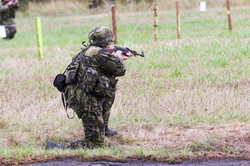 Fototapeta premium soldier in a camouflage suit fights