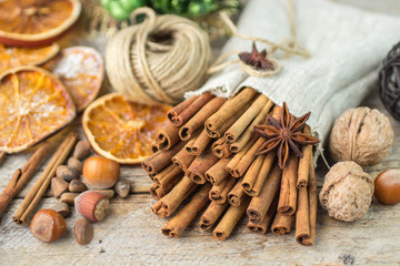 Cinnamon sticks, star anise and nuts on an old wooden table
