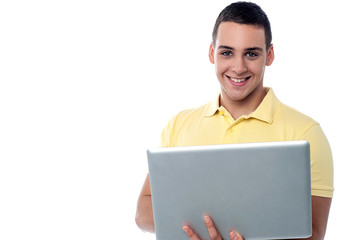 Smiling guy working on laptop
