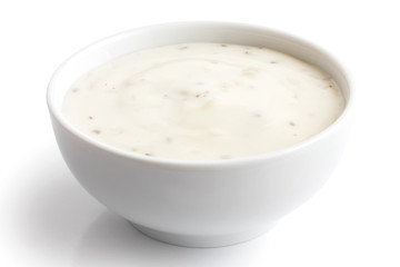Round white bowl of tortilla sour cream dip isolated in perspect