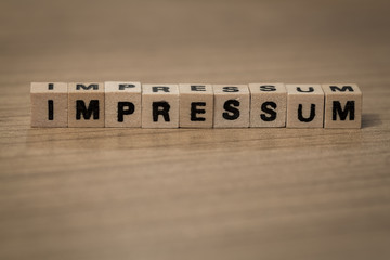 impressum in wooden cubes